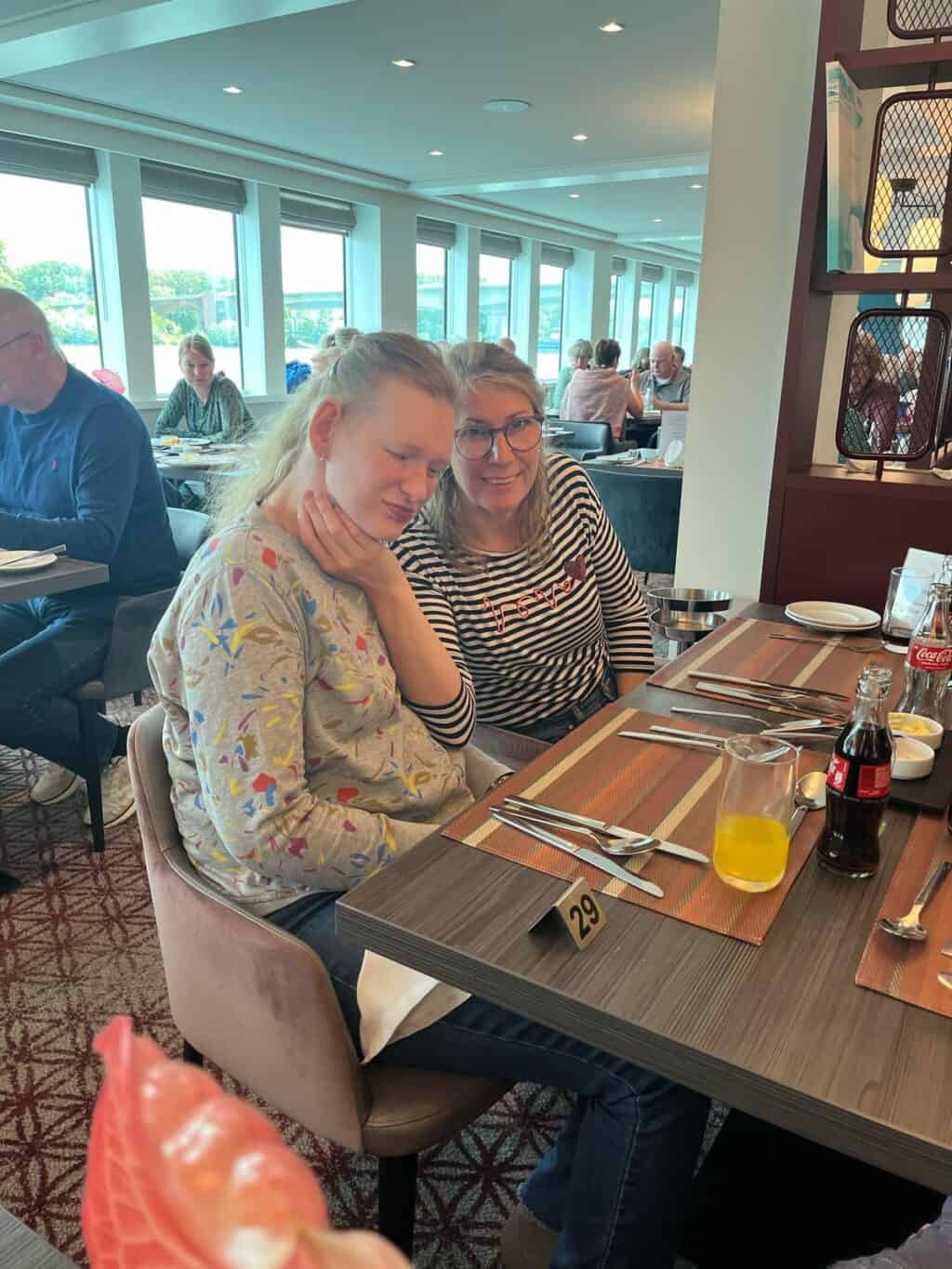 Zwei Frauen sitzen gemeinsam an einem Restauranttisch.